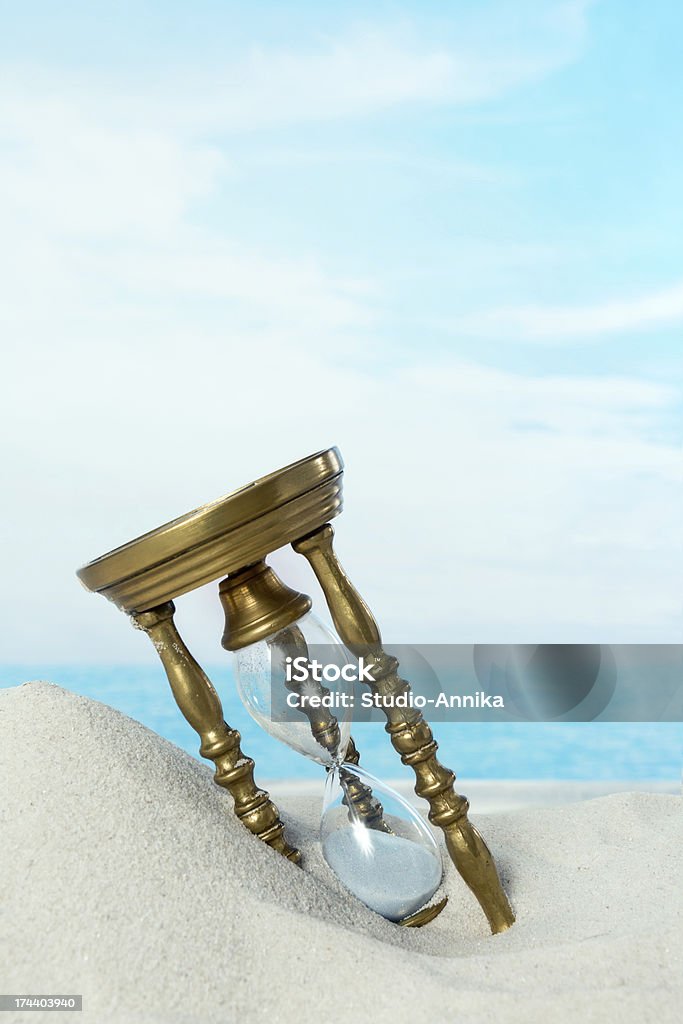 Hourglass on the beach Old hourglass lying in the beach sand Abandoned Stock Photo