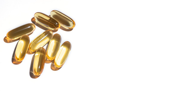 soft gel omega 3 pills or fish oils capsules on white background. Banner, copy space