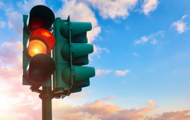 istock Green traffic light with burning yellow lamp supervisory road. T 1744054941