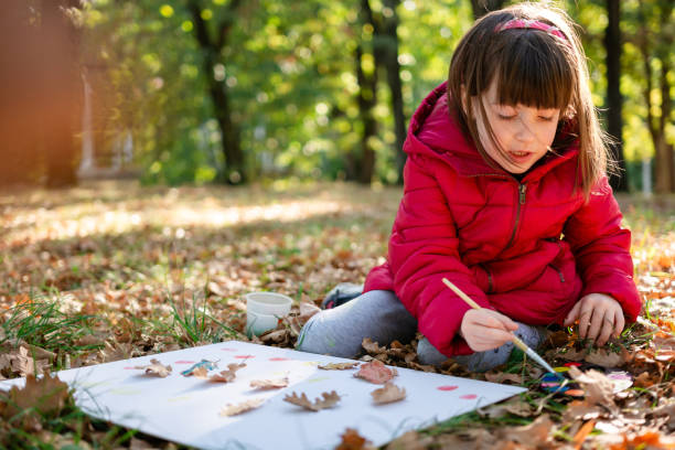 istock Small creative girl painting in nature 1744060552