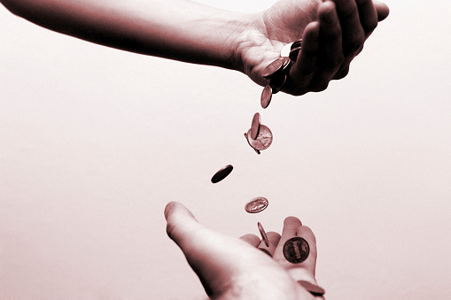 Money falling from one hand to another. Could conceptually represent taxes, inflation, charity, 