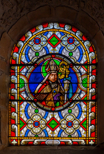 Val d'Oingt, France - 08 29 2021: Rhône Vineyard. View of the stained glass medallion of Saint Bonnet in the church of Oingt, medieval building