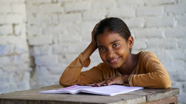 istock Indian school child sitting at desk in classroom with notebooks writing test Elementary school, Education concept. 1744091025