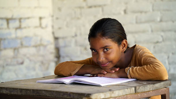 istock Indian school child sitting at desk in classroom with notebooks writing test Elementary school, Education concept. 1744093290