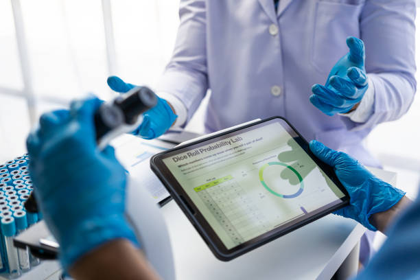 istock Two scientists working on a medical experiment in a laboratory, two doctors in protective clothing working and examining chemicals in a laboratory A team of researchers is working on a test tube. 1744097783