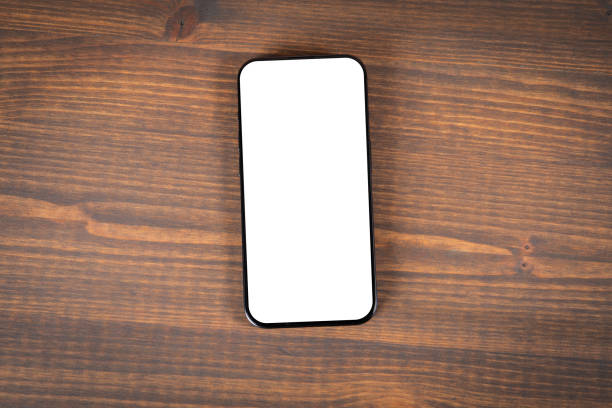 istock Mobile phone on old wooden desk background 1744114516