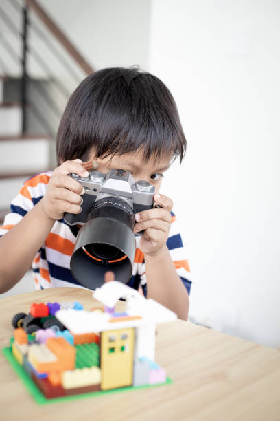 istock Asian little boy 5 years old taking photo using digital mirrorless camera. 1744114520