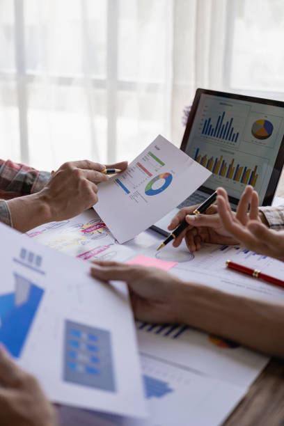 istock Analyzing business financial reports on laptop and laptop document graphs during corporate meeting discussion which shows successful teamwork Vertical close-up image 1744117549