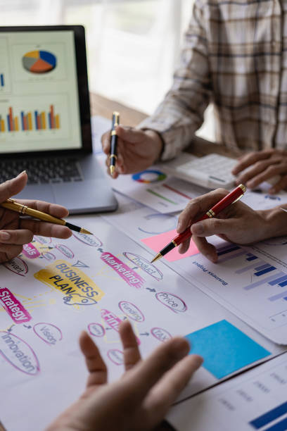 istock Analyzing business financial reports on laptop and laptop document graphs during corporate meeting discussion which shows successful teamwork Vertical close-up image 1744117567