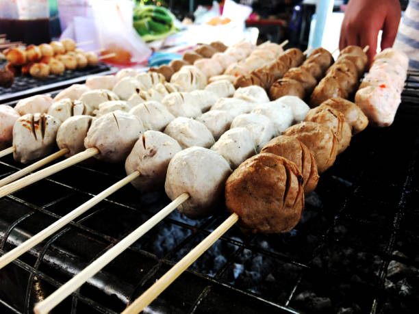 istock Hands' Merchant toasting Pork Meat Ball on Toaster 1744123417