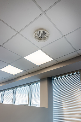 White ceiling with modern lighting in office.