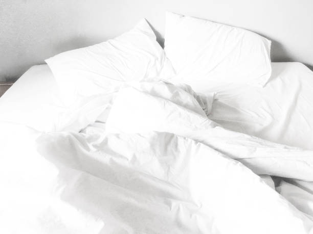 istock Two white pillow on bed with wrinkle messy blanket in bedroom background 1744141467