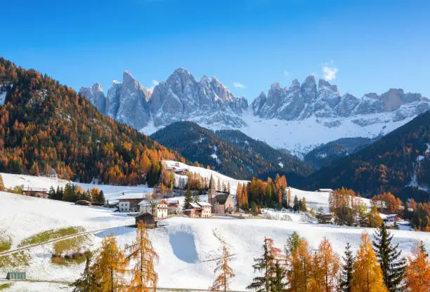 Photo of Colorful autumn landscape of Dolomite Alps.
The small village of St. Magdalena ( Santa Maddalena) with the Geisler/Odle Peaks on background, Val di Funes, South Tyrol, Italy.