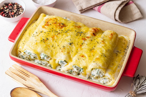Italian cannelloni with cheese and spinach. Italian food. Vegetarian food with cheese and spinach. Italian food. Vegetarian food