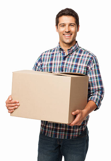 Happy Young Man Carrying a Cardboard Box - Isolated stock photo