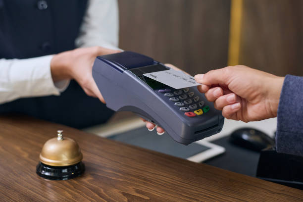 istock Woman using credit card to pay for room 1744189080