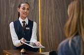 Manager registrating guest in the hotel