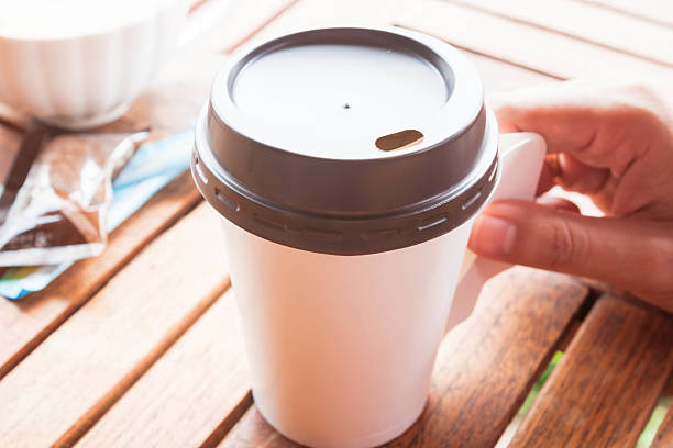 istock Hot coffee in paper cup serving on wood table 174419305