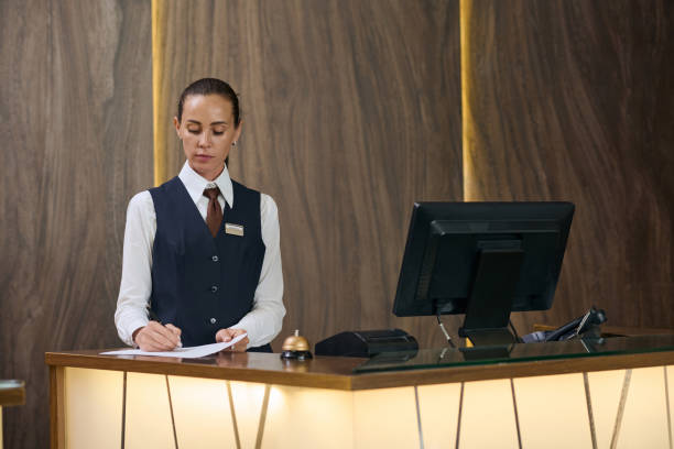 istock Receptionist signing documents behind the reception desk 1744193260