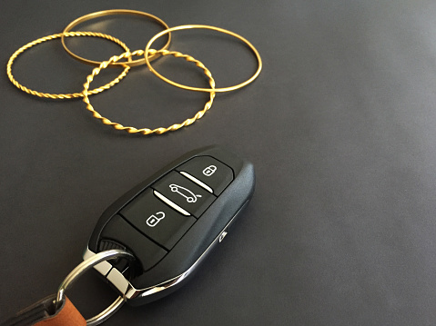 Gold bracelets and a car key. Exchange gold to buy a car. Investment concept