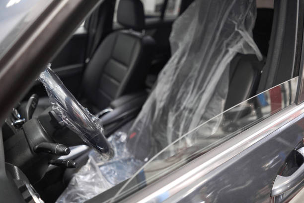 istock Put on protective covers when taking the car in service. Steering wheel with protective cover on. Car pre-sale 1744204347