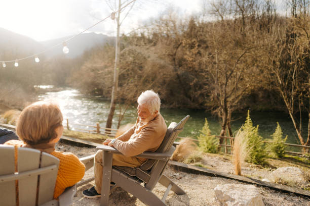 istock Senior couple enjoy sunset over the river together 1744215410