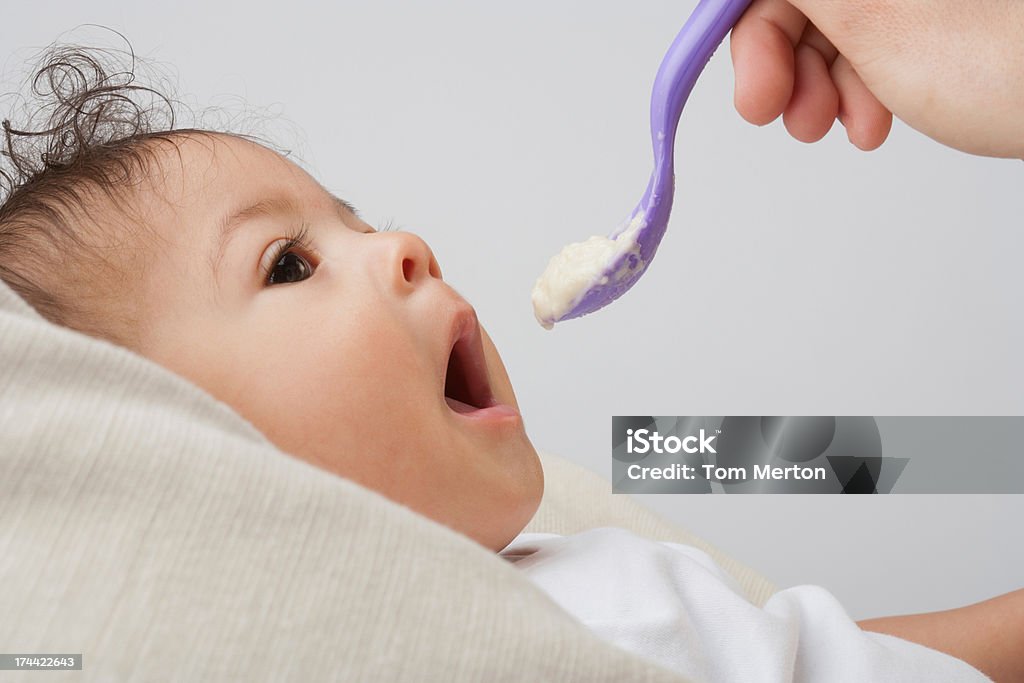 Woman hand feeding Baby  6-11 Months Stock Photo