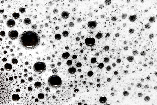 istock Soap bubbles texture. Black teflon frying pan cleaning. White suds pattern. Liquid detergent foam. 1744229647