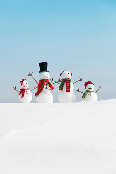 istock Snowman Family Christmas with Blue Sky Copy Space Vertical 174423252