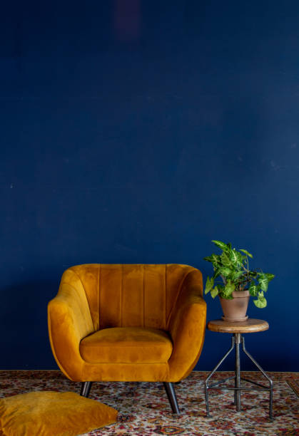 istock Interior element, yellow empty armchair against blue wall background, copy space 1744237098