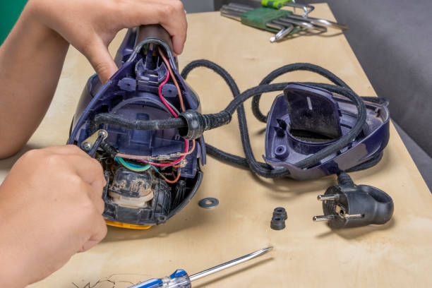 istock Disassembled electric iron. repairman checking and fixing broken iron 1744240356