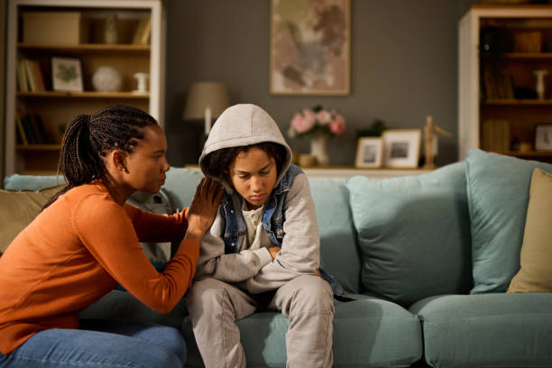 istock Mother comforting her son at home- teenage problems 1744254465