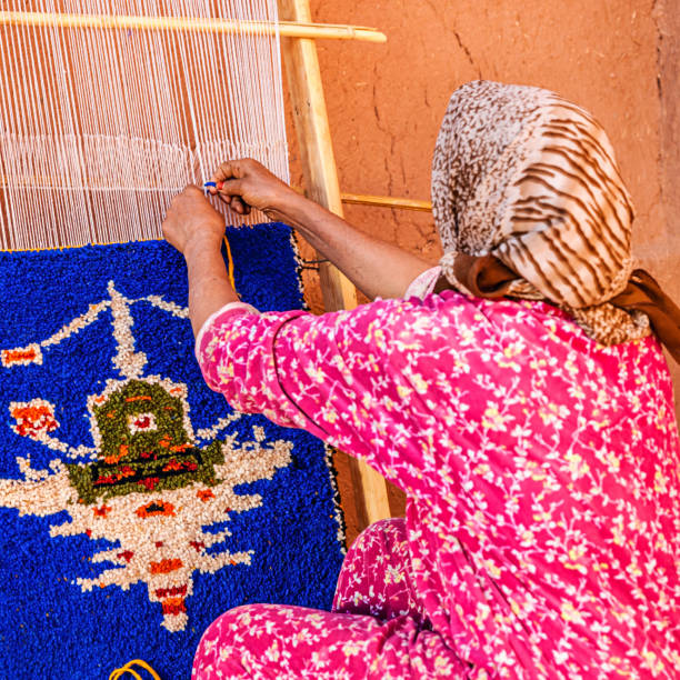 istock Berber woman weaving textiles, Ouarzazate, Morocco 174425548