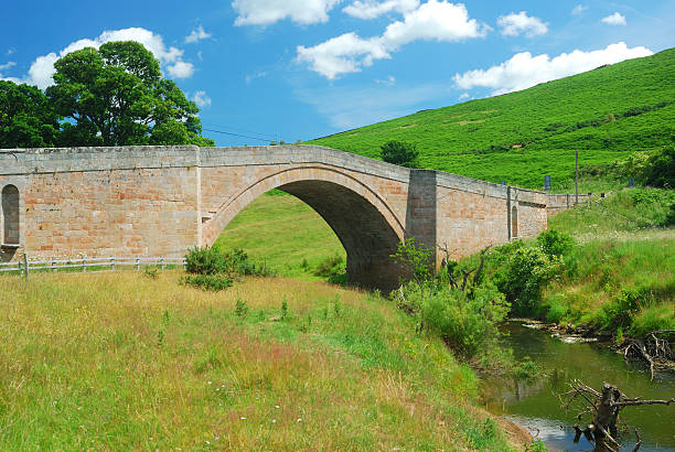 old bridge and stream near Wooler, Northumberland stock photo