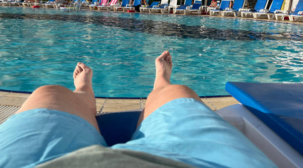 istock Senior man sunbathing at the swimming pool 1744264049