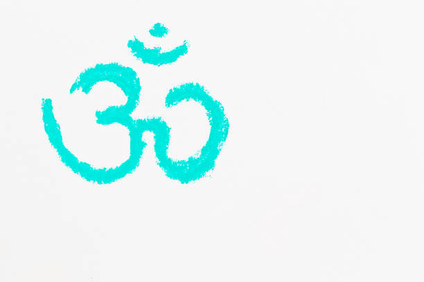 A vivid turquoise chalk drawing - the color of the Heart Chakra - of the Sanskrit Om, Ohm, or Aum symbol on a white sketchpad. A reminder to meditate perhaps?