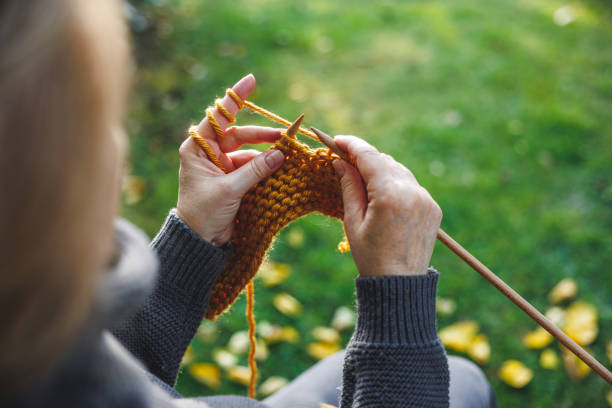 istock Woman knitting scarf with wool 1744282615
