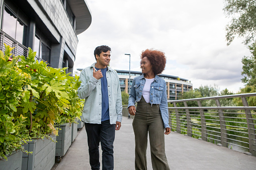 Two cheerful friends having fun together in a modern town centre