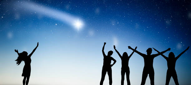 istock Women as silhouette hold ceremony in front of starry sky 1744306204
