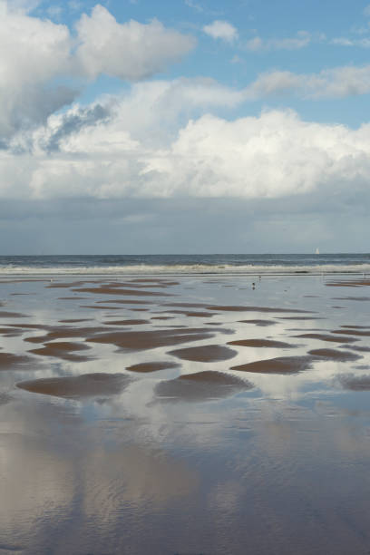 istock Reflection on the beach at low tide. Blue sky with clouds. Seascape 1744306800
