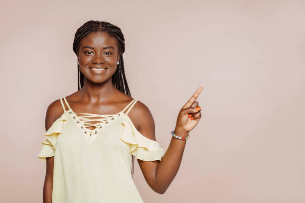 istock Young african girl pointing to the side 1744314969