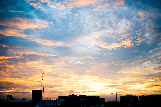 istock Sunrise over city with cloudy sky 174432367