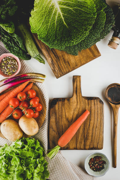 istock Local homegrown vegetables with wooden board on a table. 1744325147