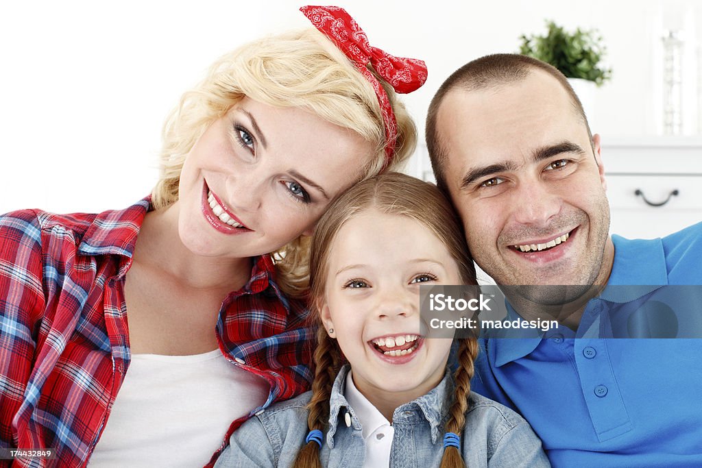Happy Family of Three Close Up Portrait Portrait of a happy family, parents with their daughter smiling at camera. 25-29 Years Stock Photo