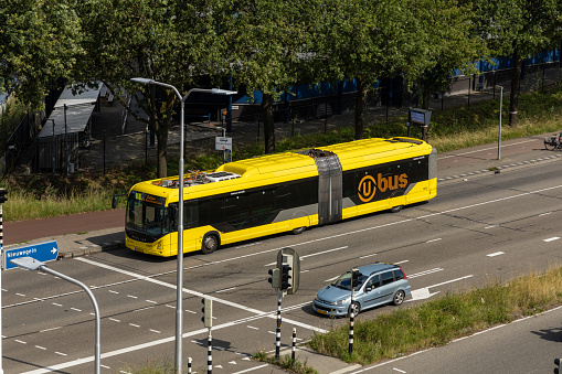 Utrecht, the Netherlands. 12 July 2023. Yellow electric city bus at station P+R Westraven in Utrecht going to Utrecht central station. Bus seen from above.