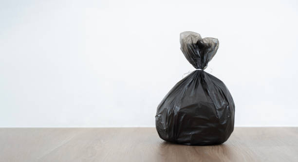 istock Close up garbage bag on wooden floor with white background. 1744356326