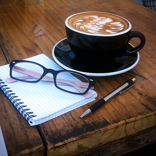 Coffee, glasses, pen and paper. stock photo