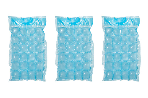 Blue plastic packaging ice bags for home water freezing isolated on white background. Ice cubes in plastic bag texture background. Freezer for ice circle cubes