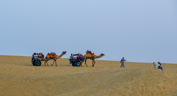 Jaisalmer, India - Nov 8, 2017. Riding camel on Thar Desert in Jaisalmer, India. Thar Desert is a large arid region in the northwestern part of the Indian.