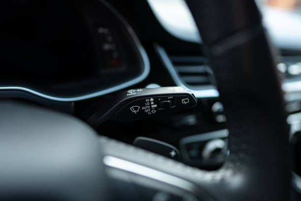 istock Selective focus of right turn signal lever being mounted on steering column inside modern vehicle. Car blinker switch activating direction indicator lights 1744378924